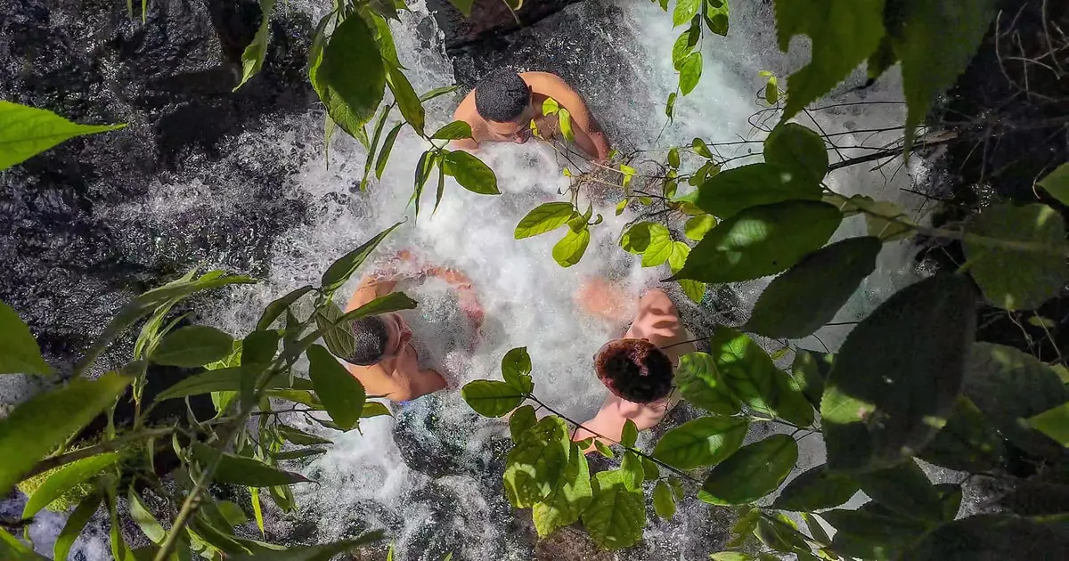 Steaming natural thermal river running through rainforest at the Pura Vida hot springs near La Fortuna, Costa Rica