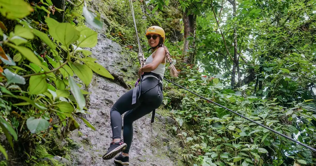 Zip line cable crossing the rainforest canopy over a river canyon on a zip line and thermal pools combo in La Fortuna, Costa Rica